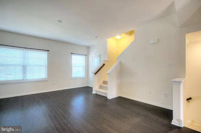 a view of an entryway with wooden floor and windows