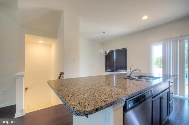 a kitchen with granite countertop sink and granite top