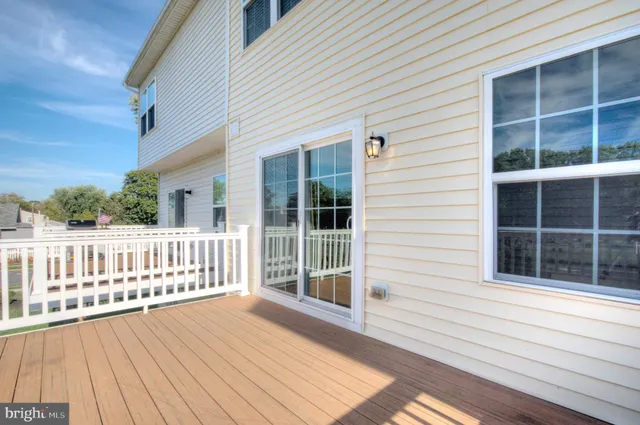 a view of a wooden deck with a yard