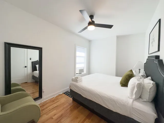 a bedroom with a bed and window