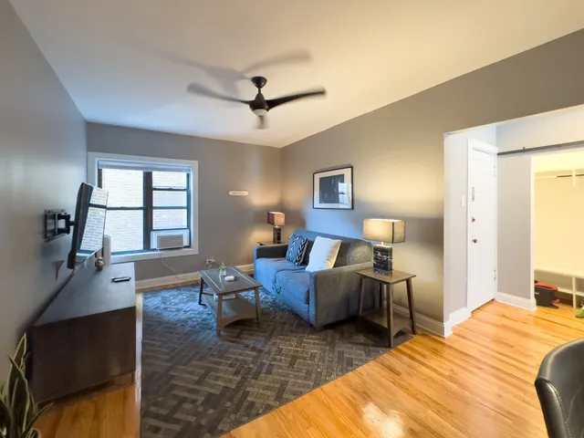 a bedroom with furniture and a wooden floor