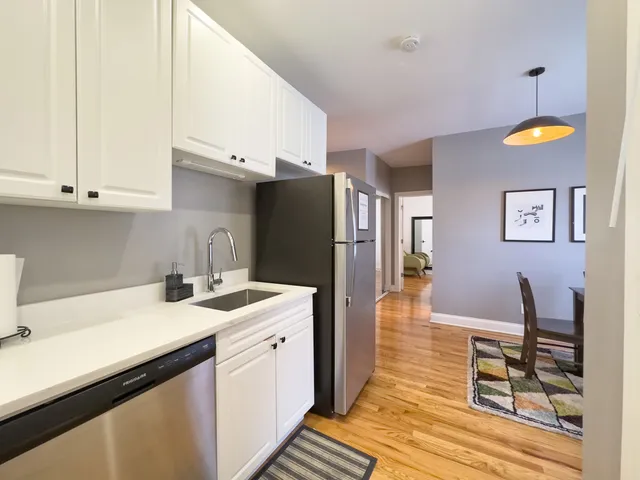 a kitchen with a sink appliances and cabinets