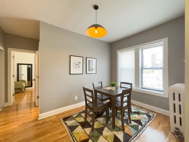 a dining room with furniture and wooden floor
