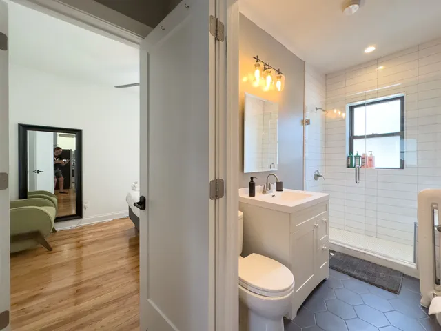 a bathroom with a sink a toilet and a mirror