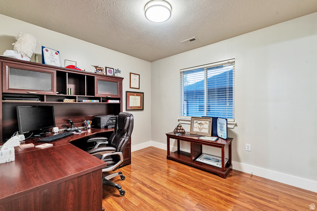Undisclosed Address Ogden, UT 84403 - Photo 18 of 21 Office space featuring a textured ceiling and light wood-style flooring