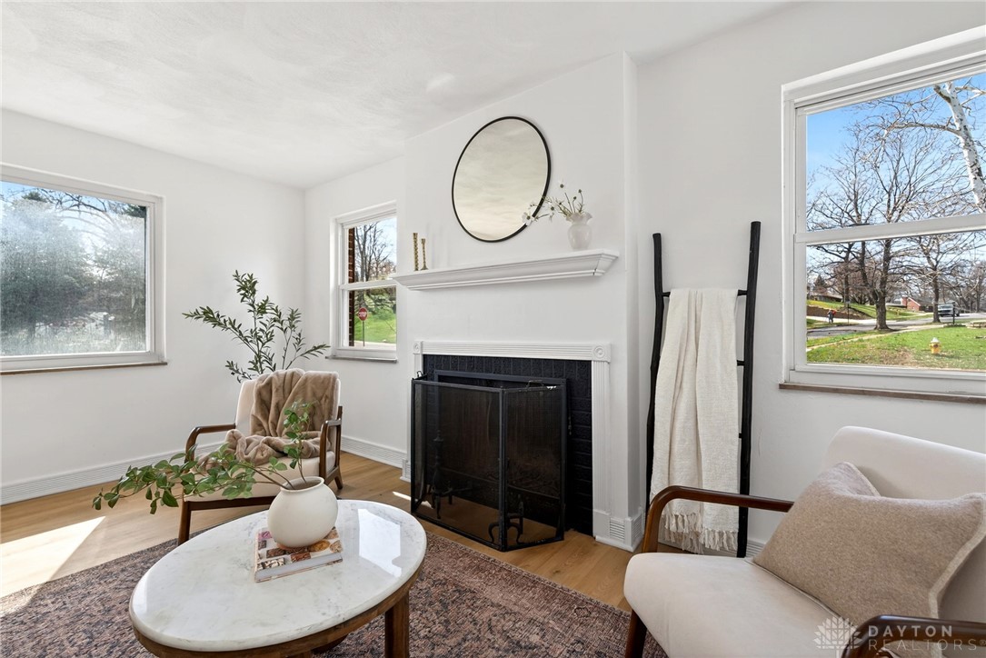 1243 Ridgeview Avenue Dayton, OH 45409 - Photo 11 of 56 This bright living space features a cozy fireplace, perfect for relaxation and gathering.