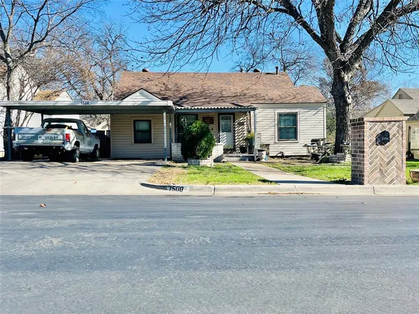 a view of a house with car parked