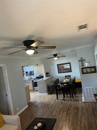 a living room with furniture and wooden floor