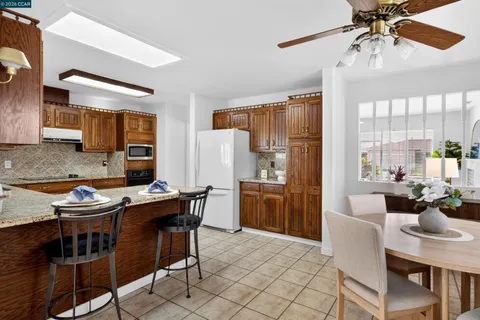 a dining room with a wooden table and chairs