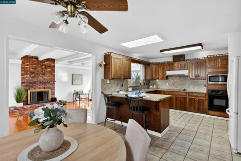 a large kitchen with cabinets a sink and appliances