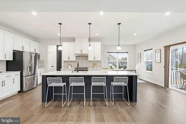 a kitchen with kitchen island a sink stainless steel appliances and cabinets