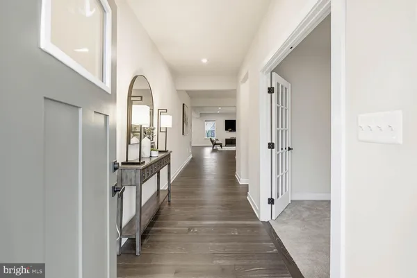 a view of a hallway with windows and entryway