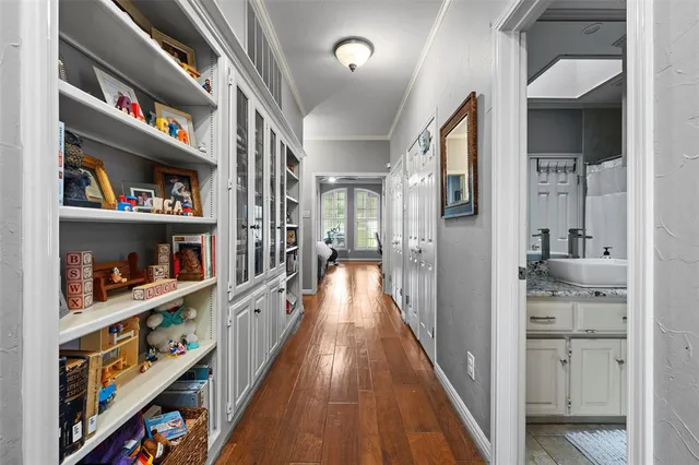 wooden floor in a room with a book shelf