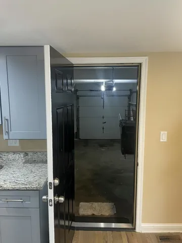 a bathroom with a granite countertop shower a mirror and a sink