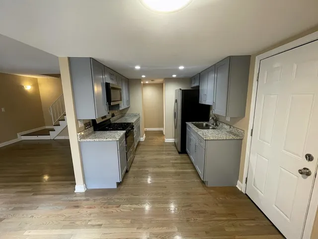 a view of a kitchen with microwave and cabinets