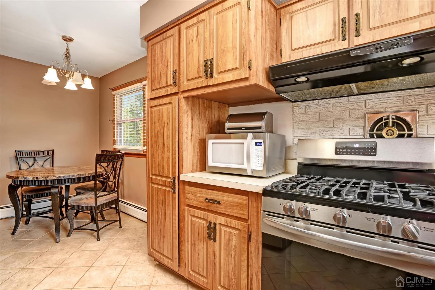 5 Weiss Drive Middlesex, NJ 08846 - Photo 11 of 24 a kitchen with stainless steel appliances granite countertop a stove and cabinets