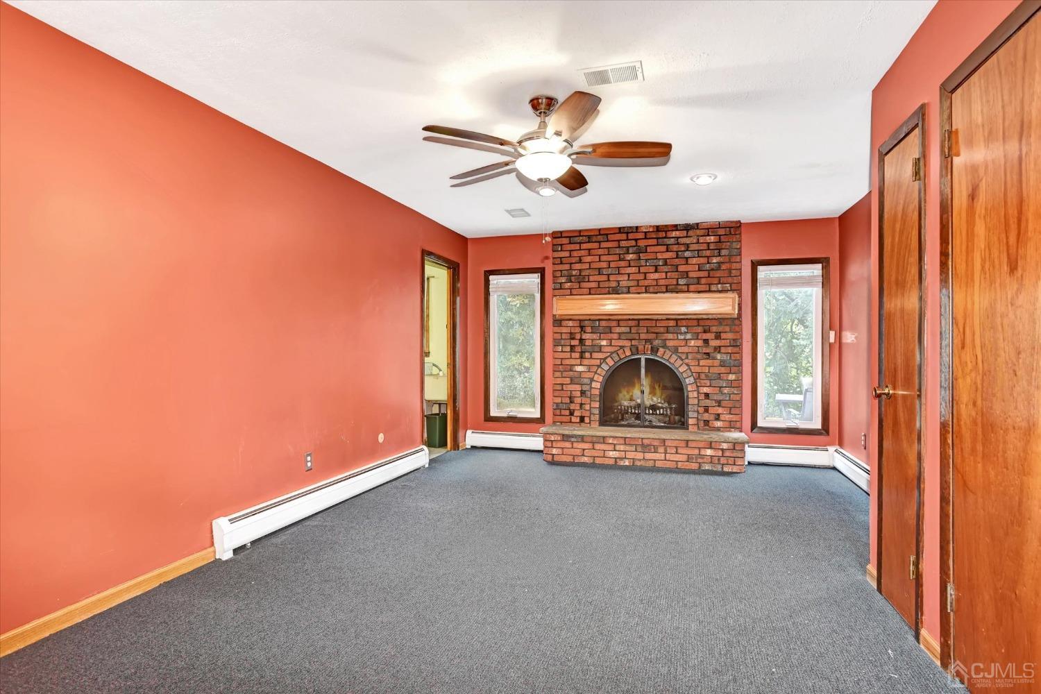 5 Weiss Drive Middlesex, NJ 08846 - Photo 14 of 24 an empty room with fireplace fan and windows