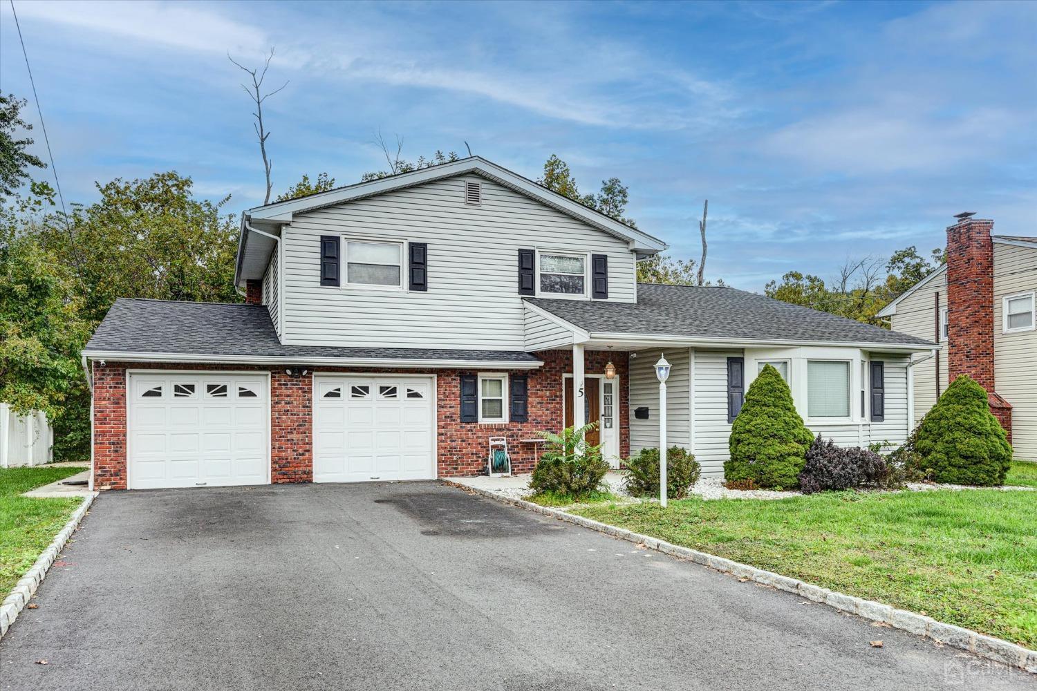 5 Weiss Drive Middlesex, NJ 08846 - Photo 20 of 24 a front view of a house with a yard and garage