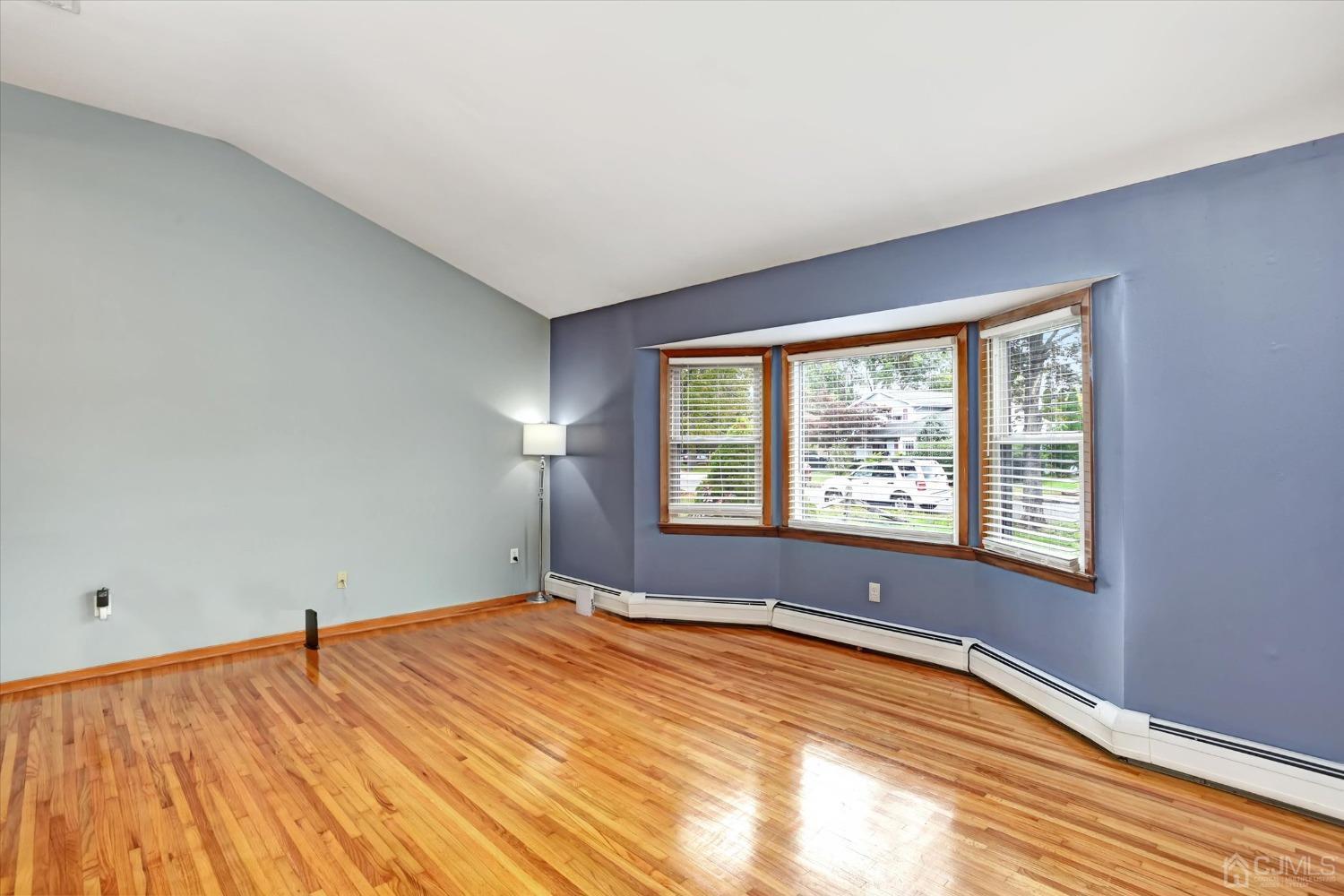 5 Weiss Drive Middlesex, NJ 08846 - Photo 2 of 24 a view of empty room with wooden floor and fan
