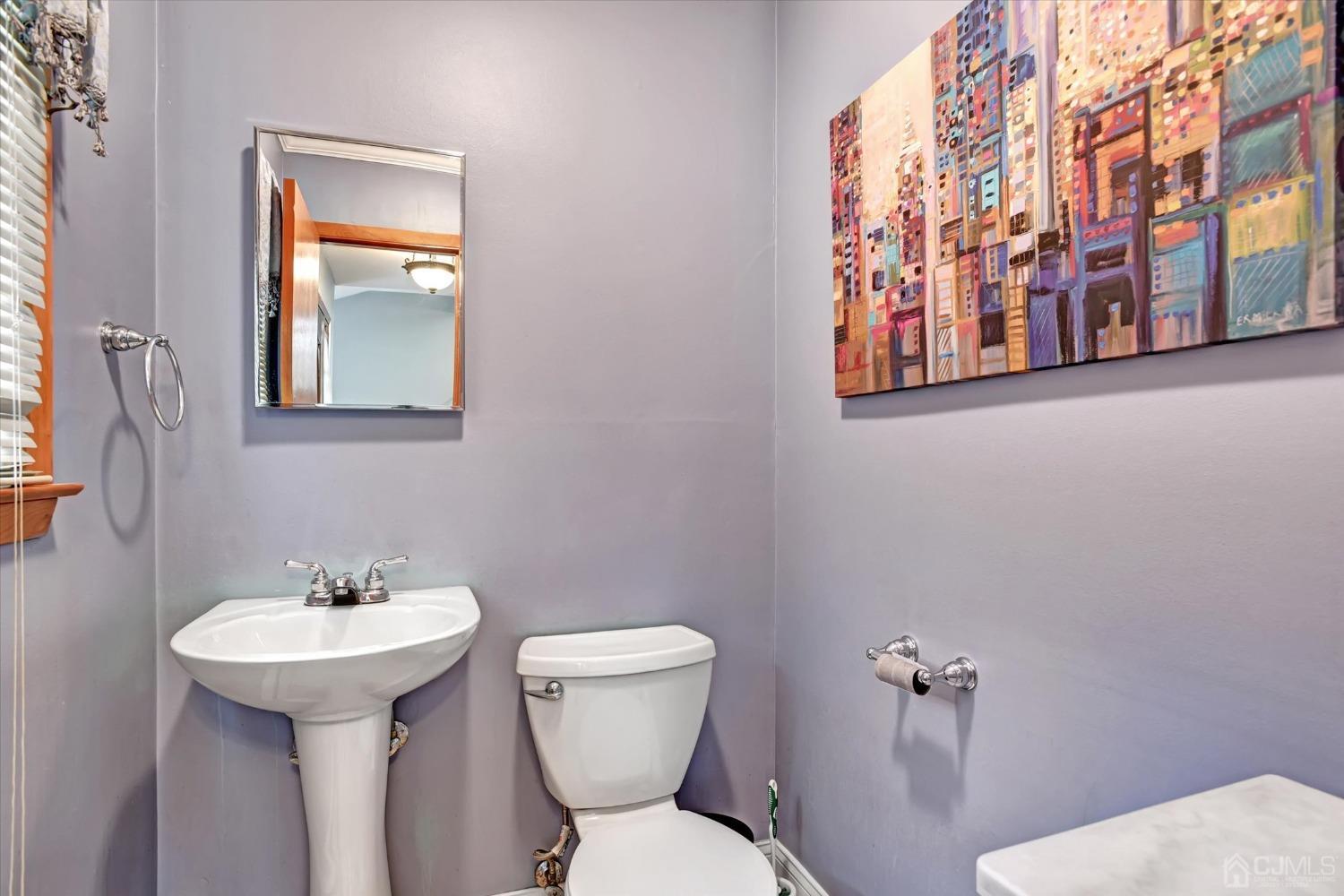 5 Weiss Drive Middlesex, NJ 08846 - Photo 24 of 24 a bathroom with a toilet sink and mirror