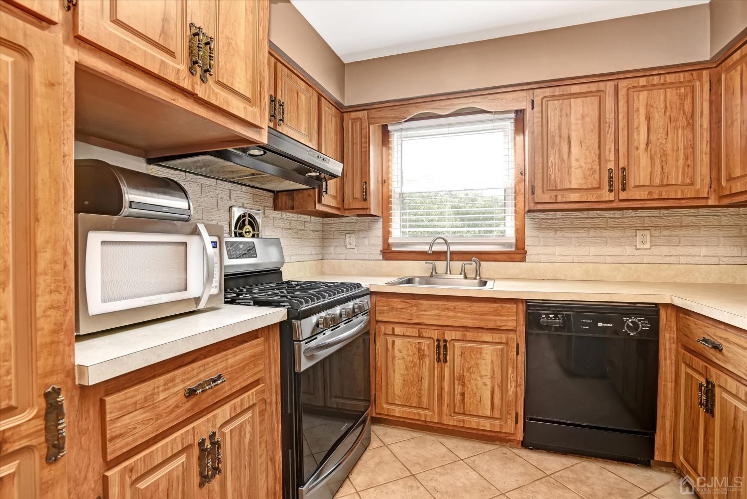 5 Weiss Drive Middlesex, NJ 08846 - Photo 7 of 24 a kitchen with a stove top oven sink and cabinets
