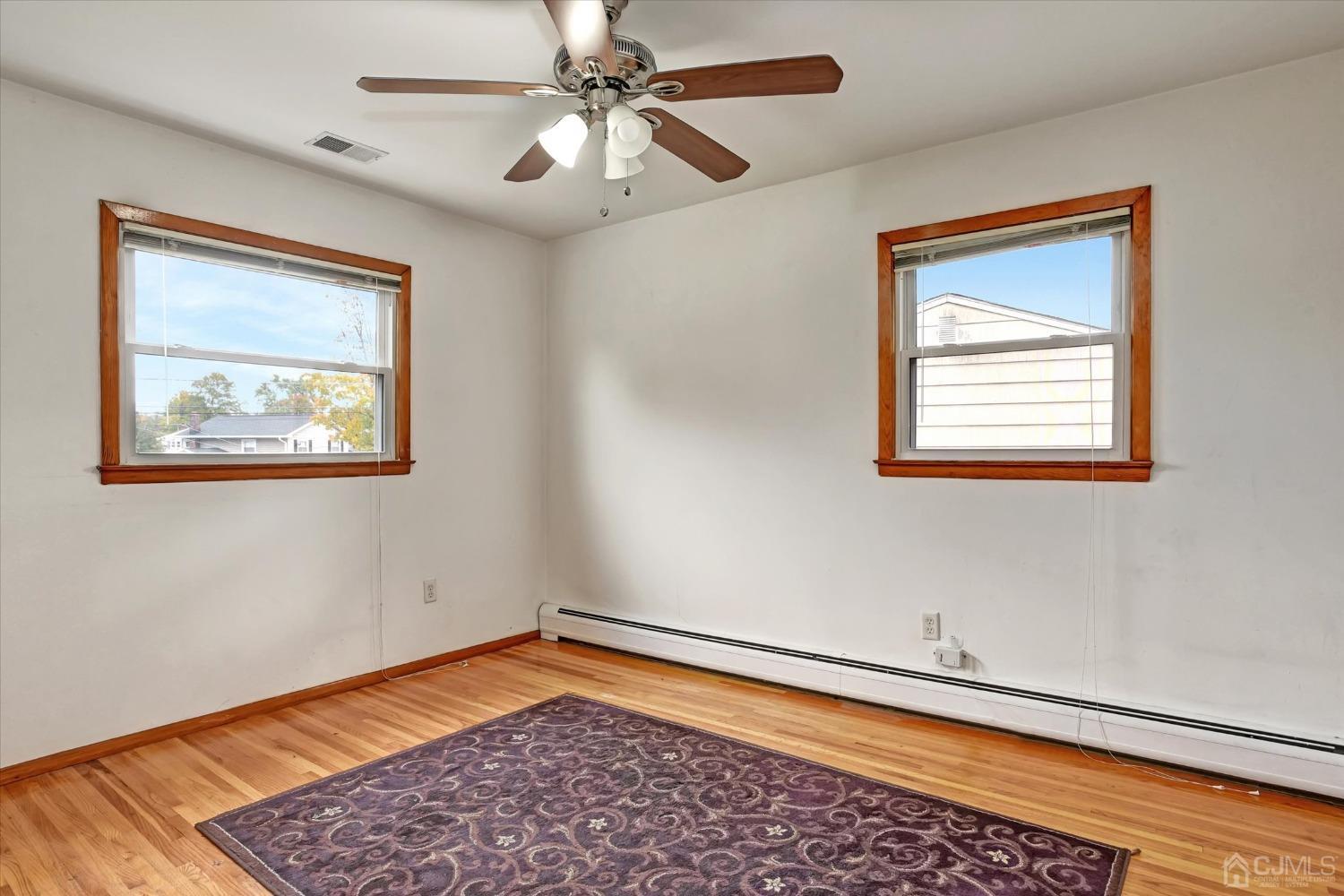 5 Weiss Drive Middlesex, NJ 08846 - Photo 8 of 24 a view of an empty room with a window and wooden floor