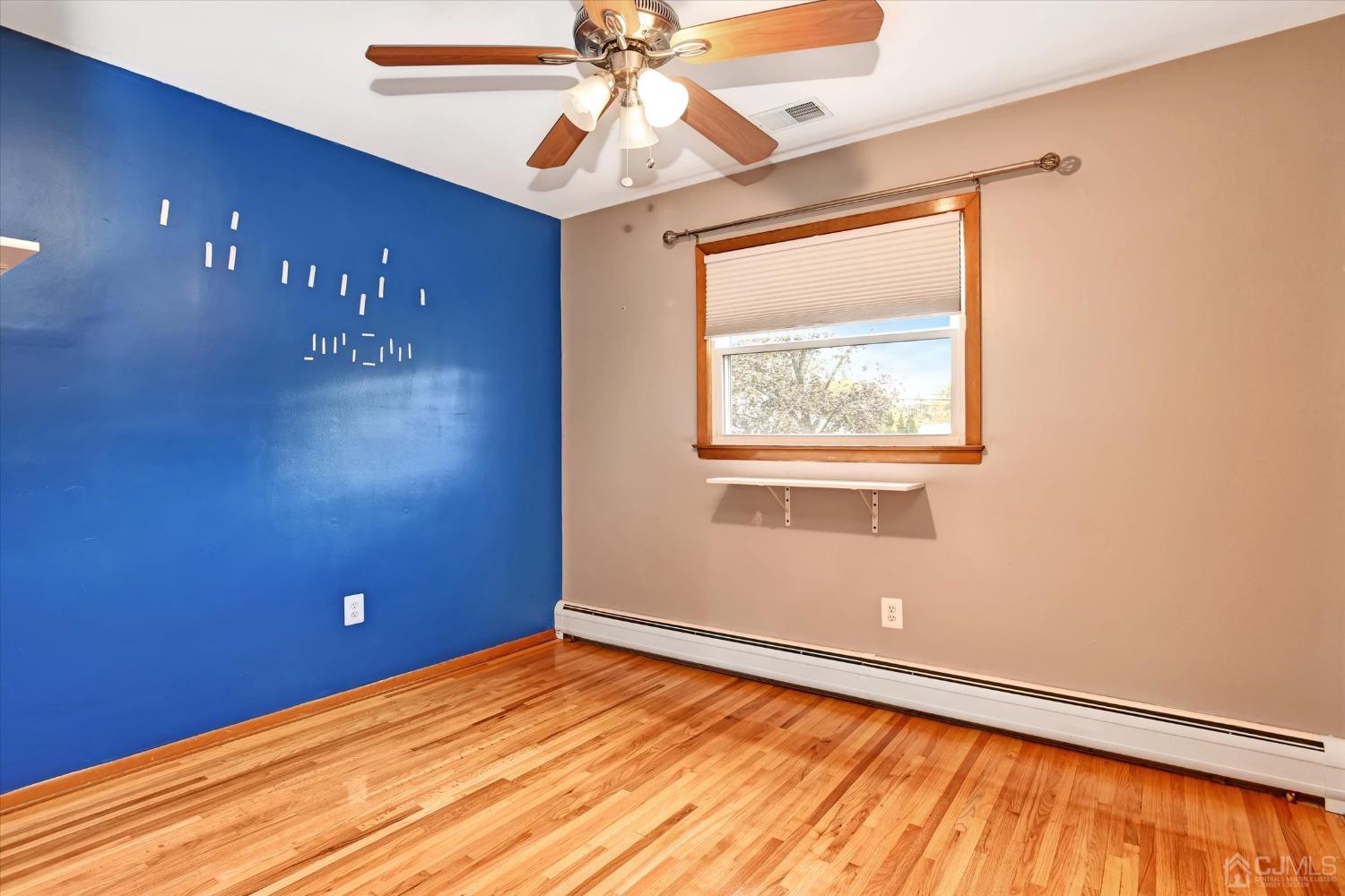5 Weiss Drive Middlesex, NJ 08846 - Photo 9 of 24 a view of an empty room with a window and a ceiling fan