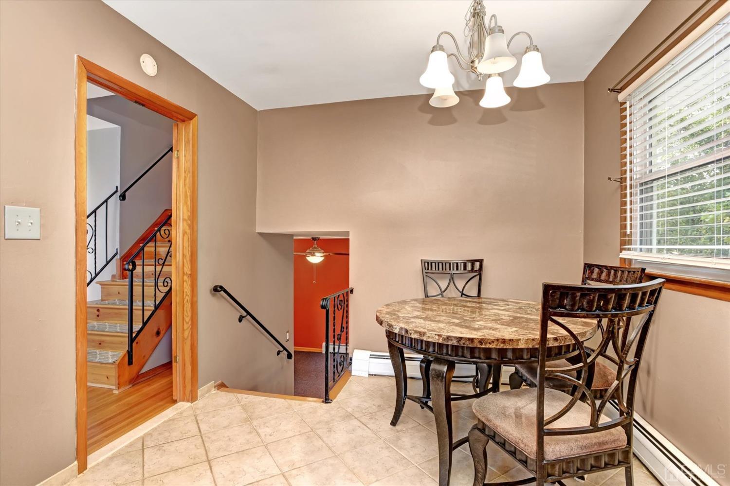 5 Weiss Drive Middlesex, NJ 08846 - Photo 10 of 24 a view of a dining room with furniture and a chandelier