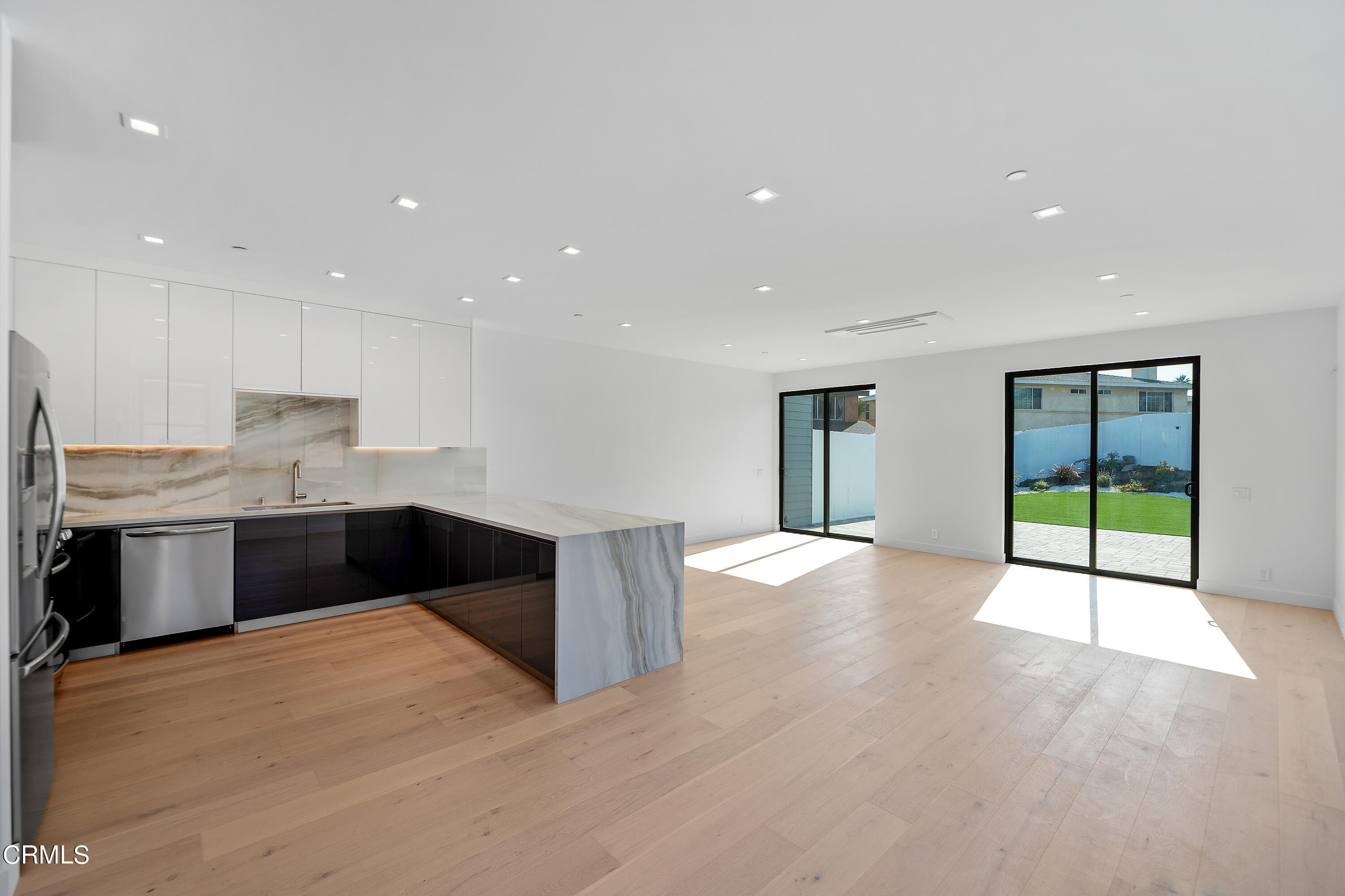 1001 Catamaran Street Oxnard, CA 93035 - Photo 13 of 37 a large white kitchen with granite countertop a large counter top stainless steel appliances and cabinets