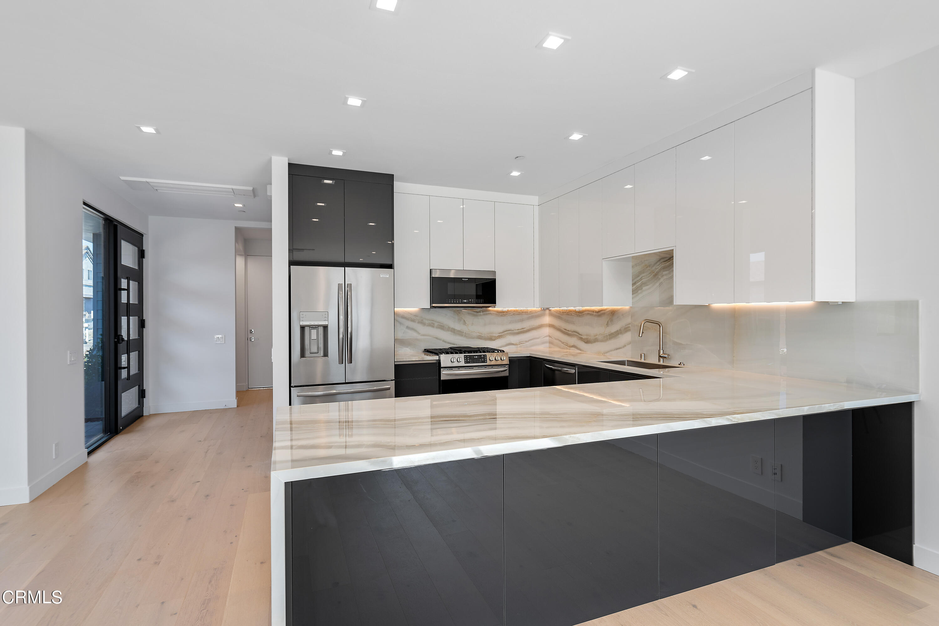 1001 Catamaran Street Oxnard, CA 93035 - Photo 15 of 37 a kitchen with a sink stainless steel appliances and cabinets