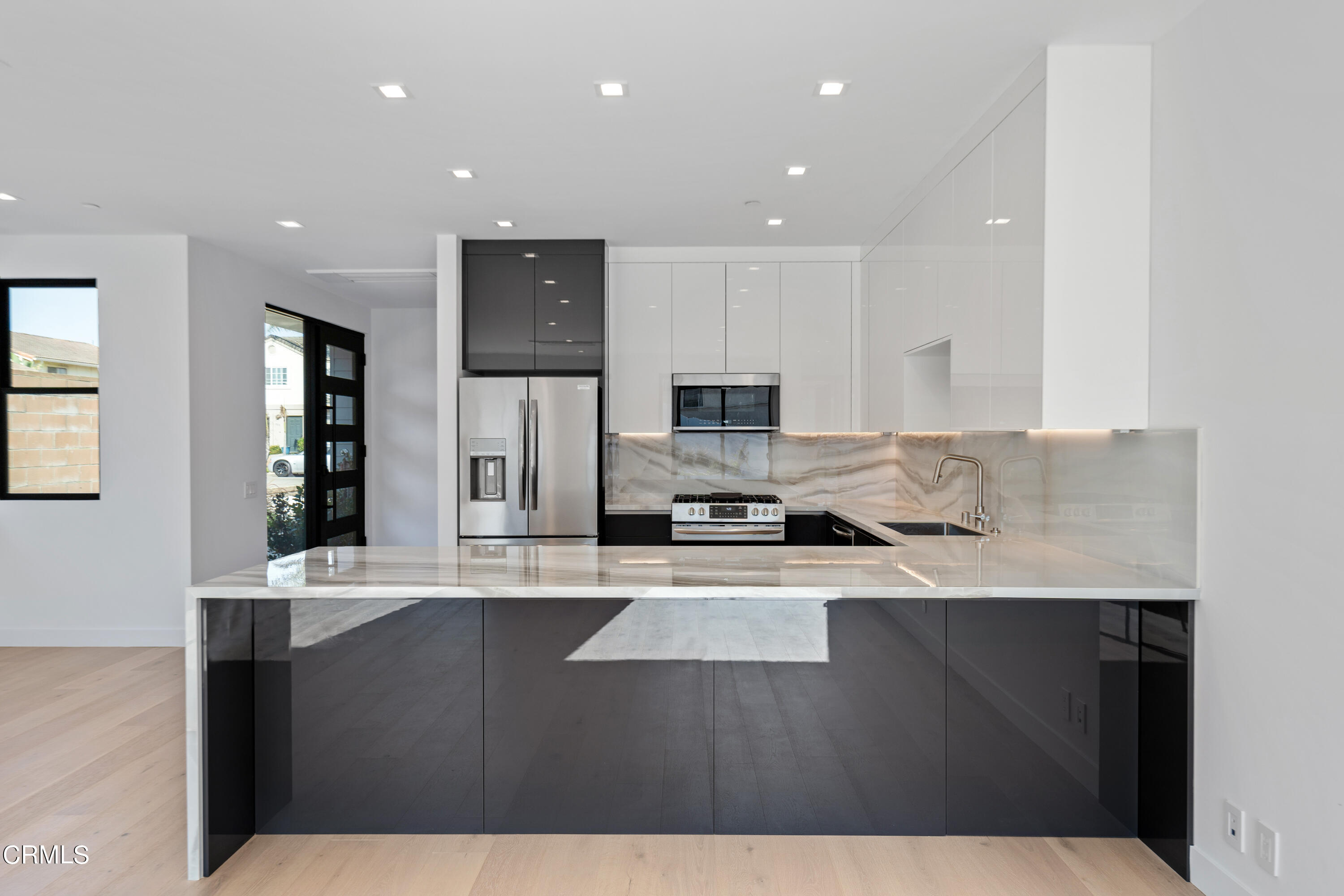 1001 Catamaran Street Oxnard, CA 93035 - Photo 16 of 37 a kitchen with stainless steel appliances granite countertop a sink a stove and cabinets