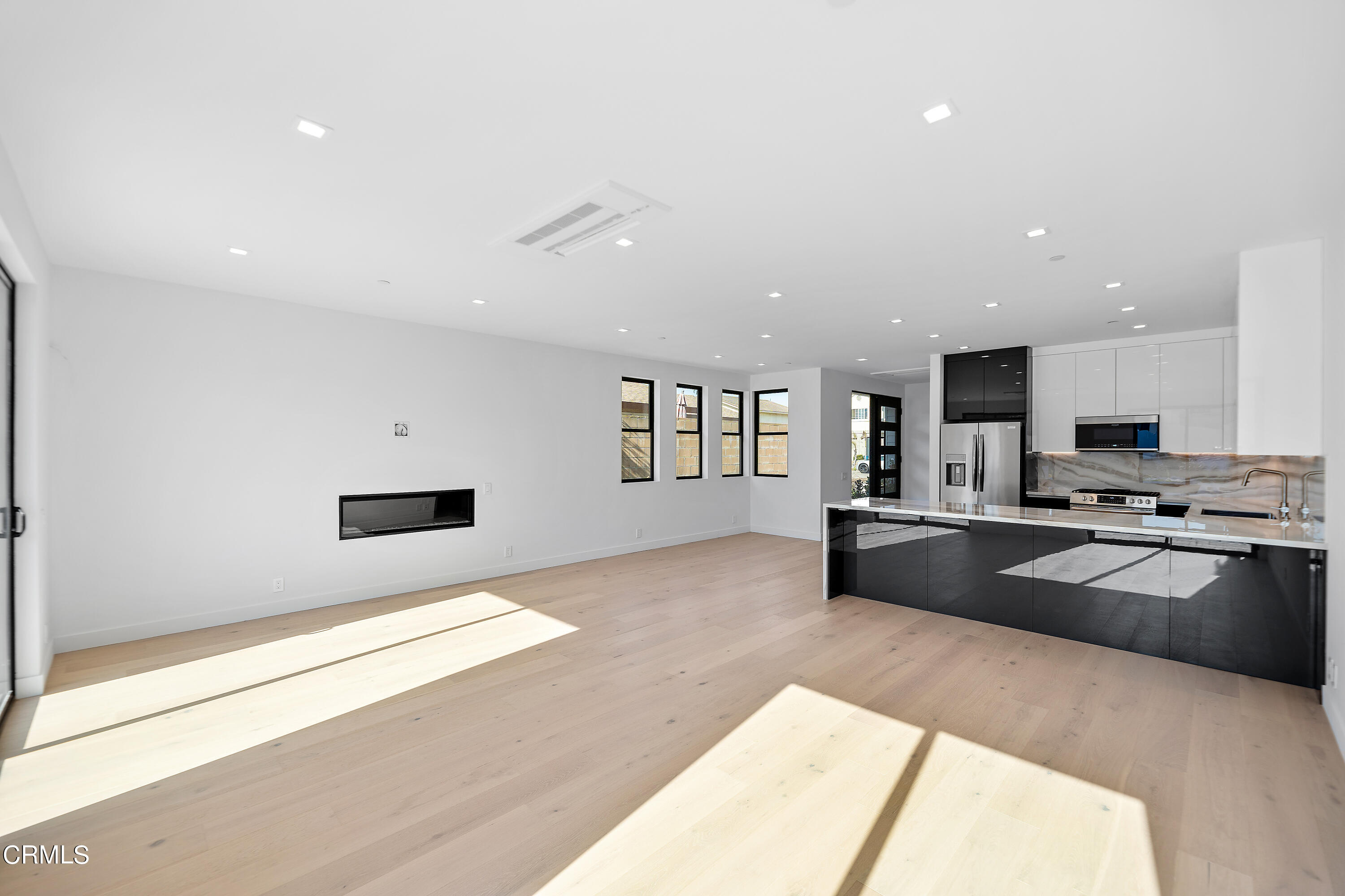 1001 Catamaran Street Oxnard, CA 93035 - Photo 20 of 37 a large kitchen with granite countertop a stove a sink dishwasher and a refrigerator with wooden floor