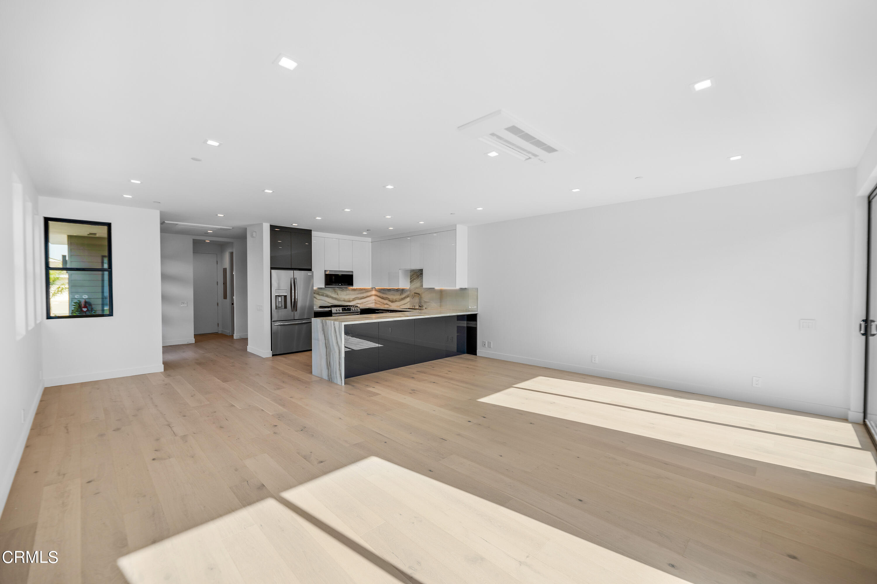 1001 Catamaran Street Oxnard, CA 93035 - Photo 21 of 37 a large white kitchen with kitchen island a sink stainless steel appliances and cabinets