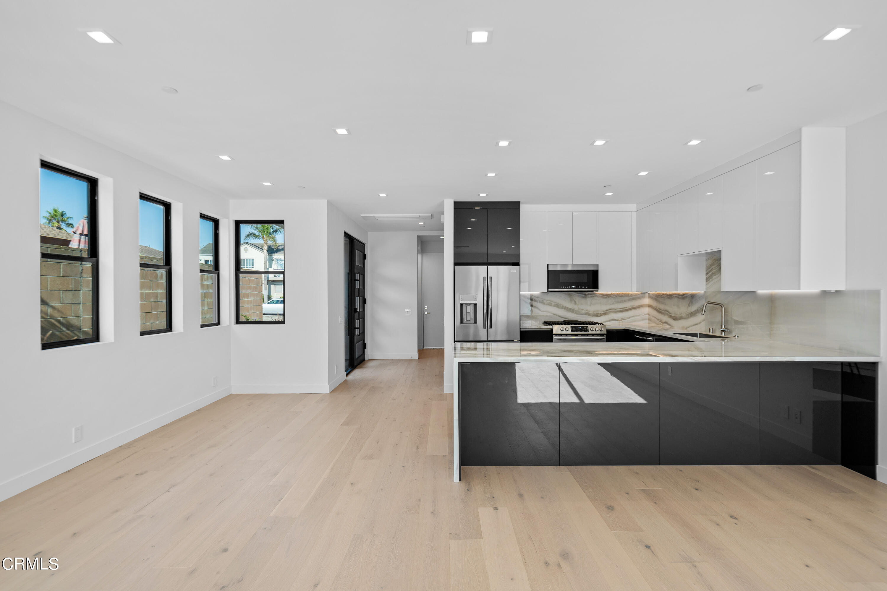 1001 Catamaran Street Oxnard, CA 93035 - Photo 22 of 37 a large kitchen with kitchen island a sink stainless steel appliances and cabinets