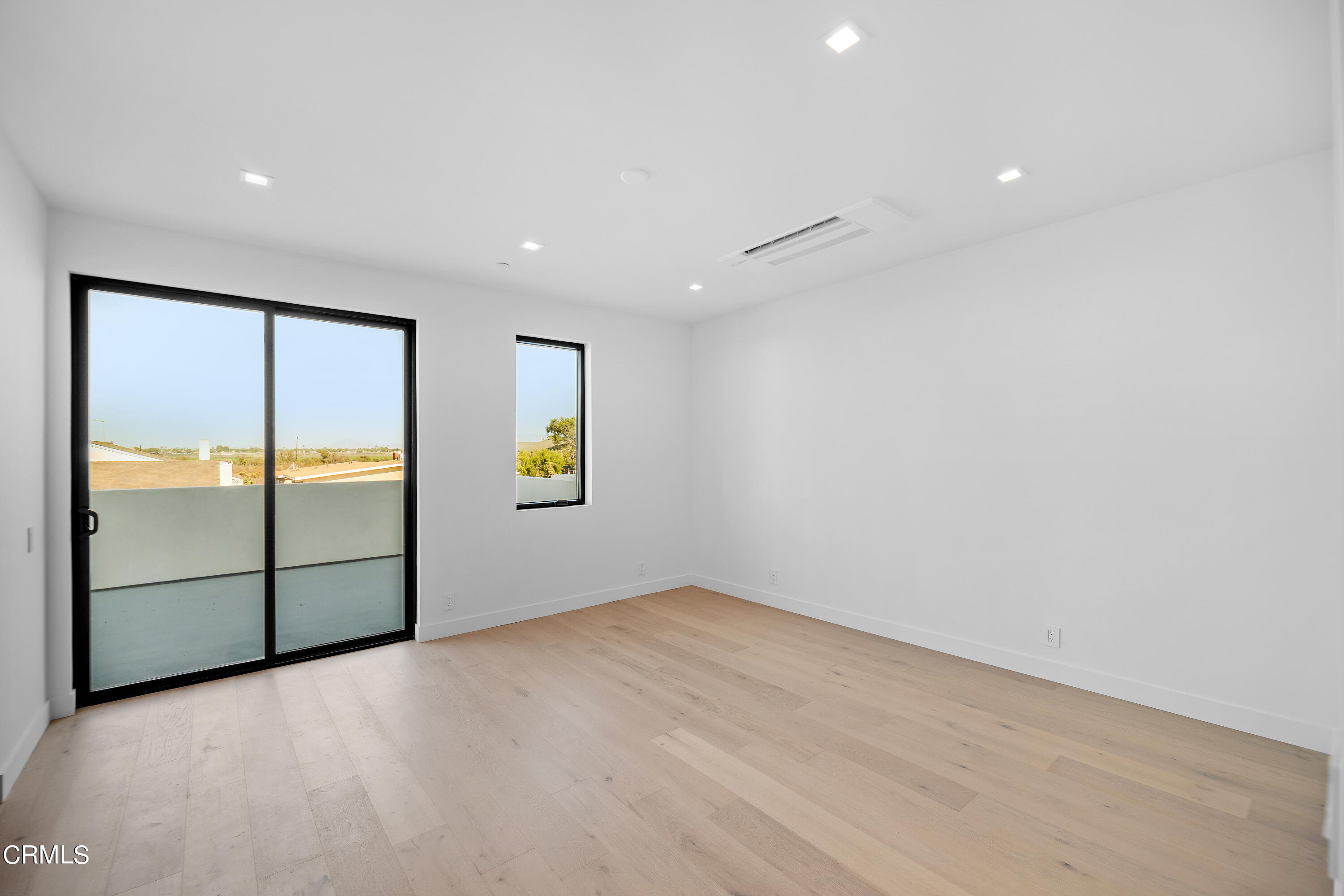 1001 Catamaran Street Oxnard, CA 93035 - Photo 25 of 37 an empty room with windows and refrigerator