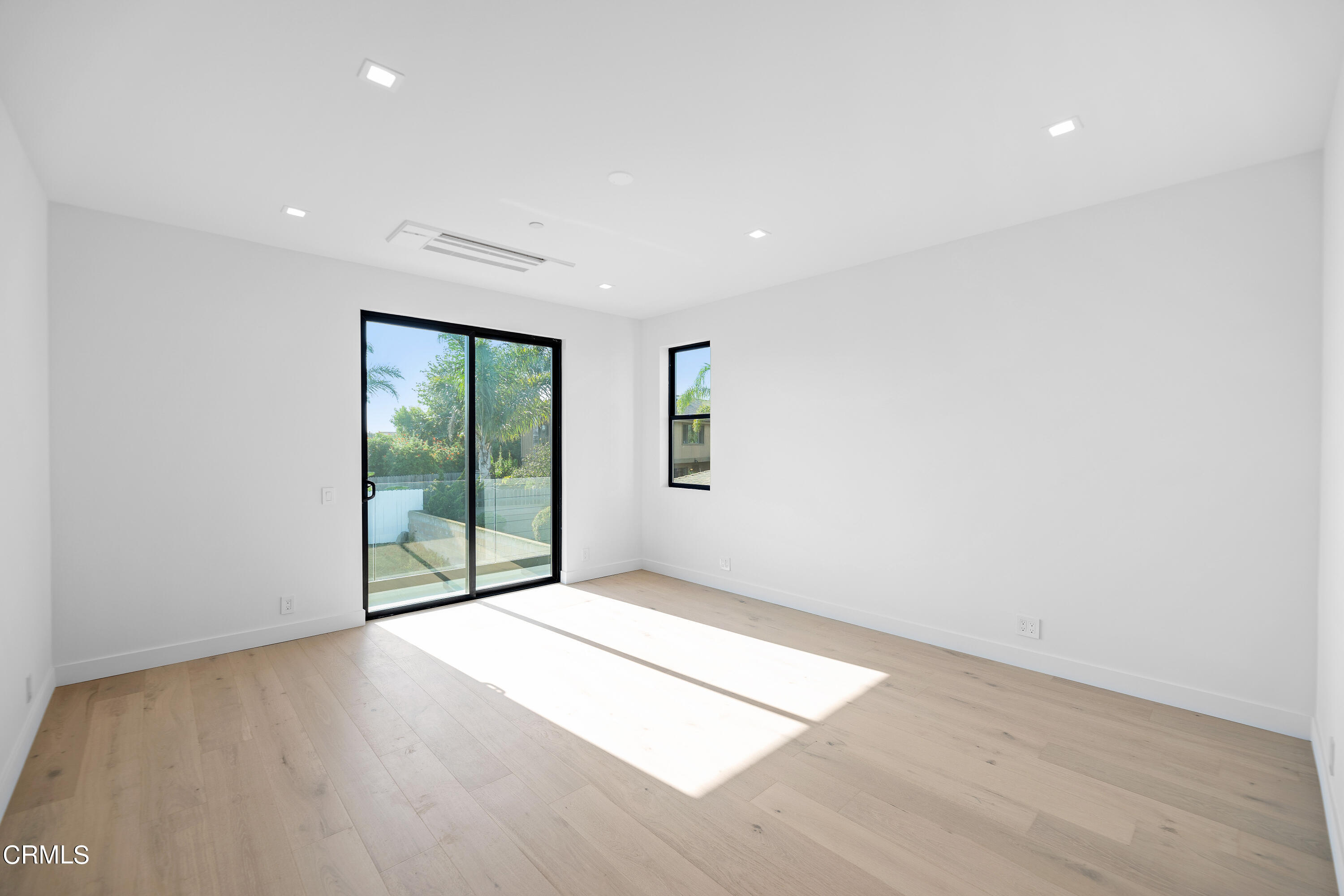 1001 Catamaran Street Oxnard, CA 93035 - Photo 33 of 37 an empty room with wooden floor and windows