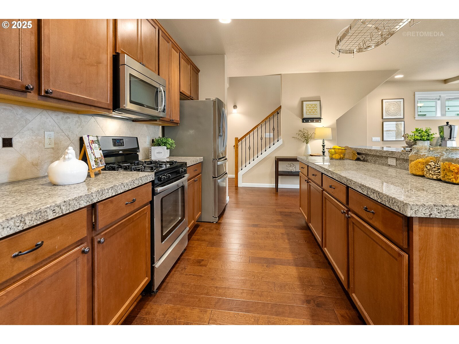 865 Southwest 90th Avenue Portland, OR 97225 - Photo 12 of 36 a kitchen with stainless steel appliances granite countertop a sink stove and refrigerator