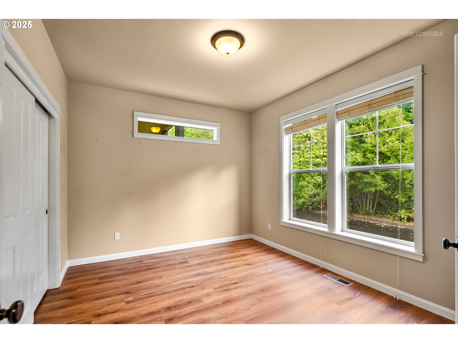 865 Southwest 90th Avenue Portland, OR 97225 - Photo 6 of 36 a view of an empty room with wooden floor and a window