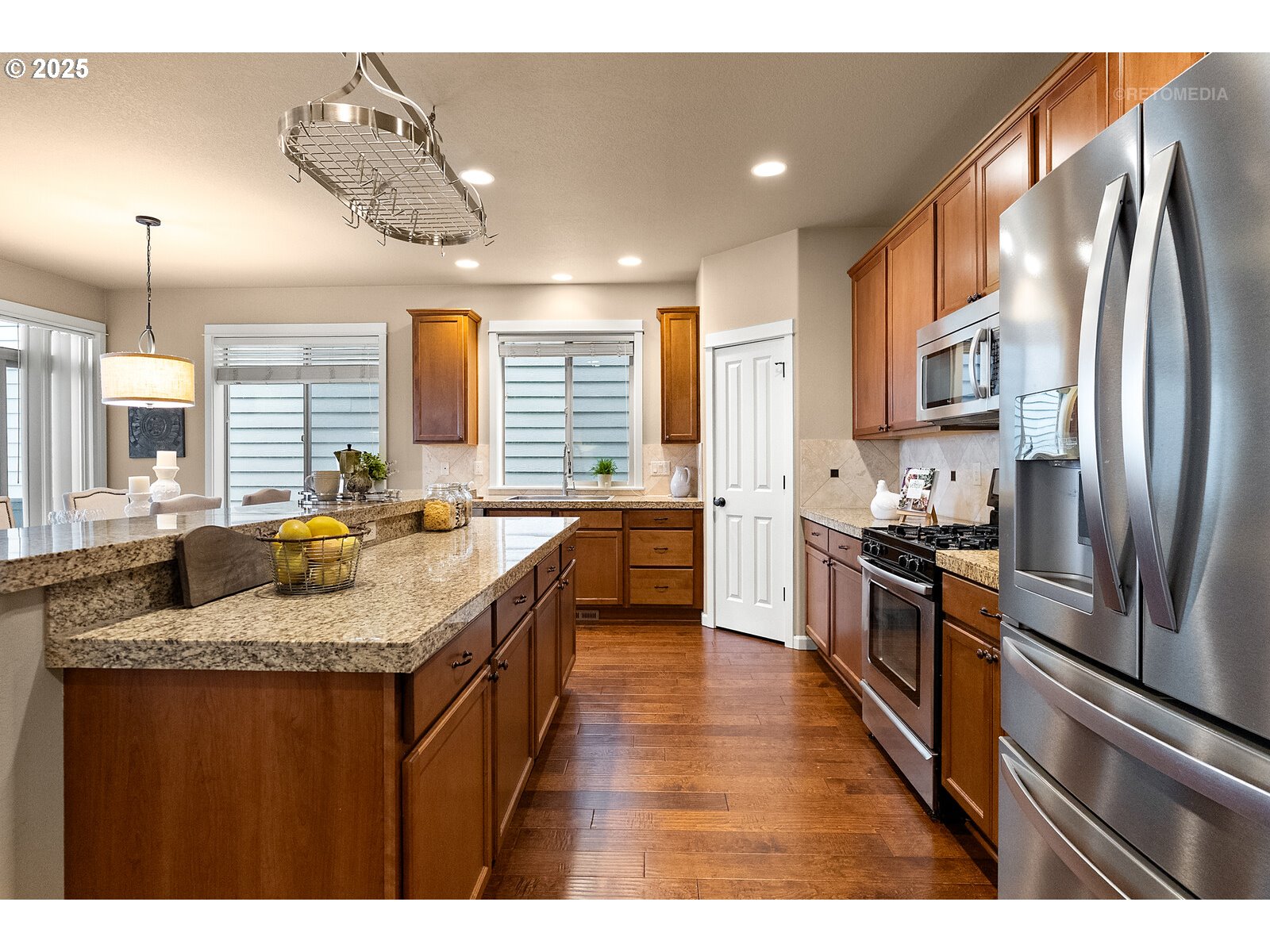 865 Southwest 90th Avenue Portland, OR 97225 - Photo 10 of 36 a kitchen with stainless steel appliances granite countertop a sink a stove and a refrigerator