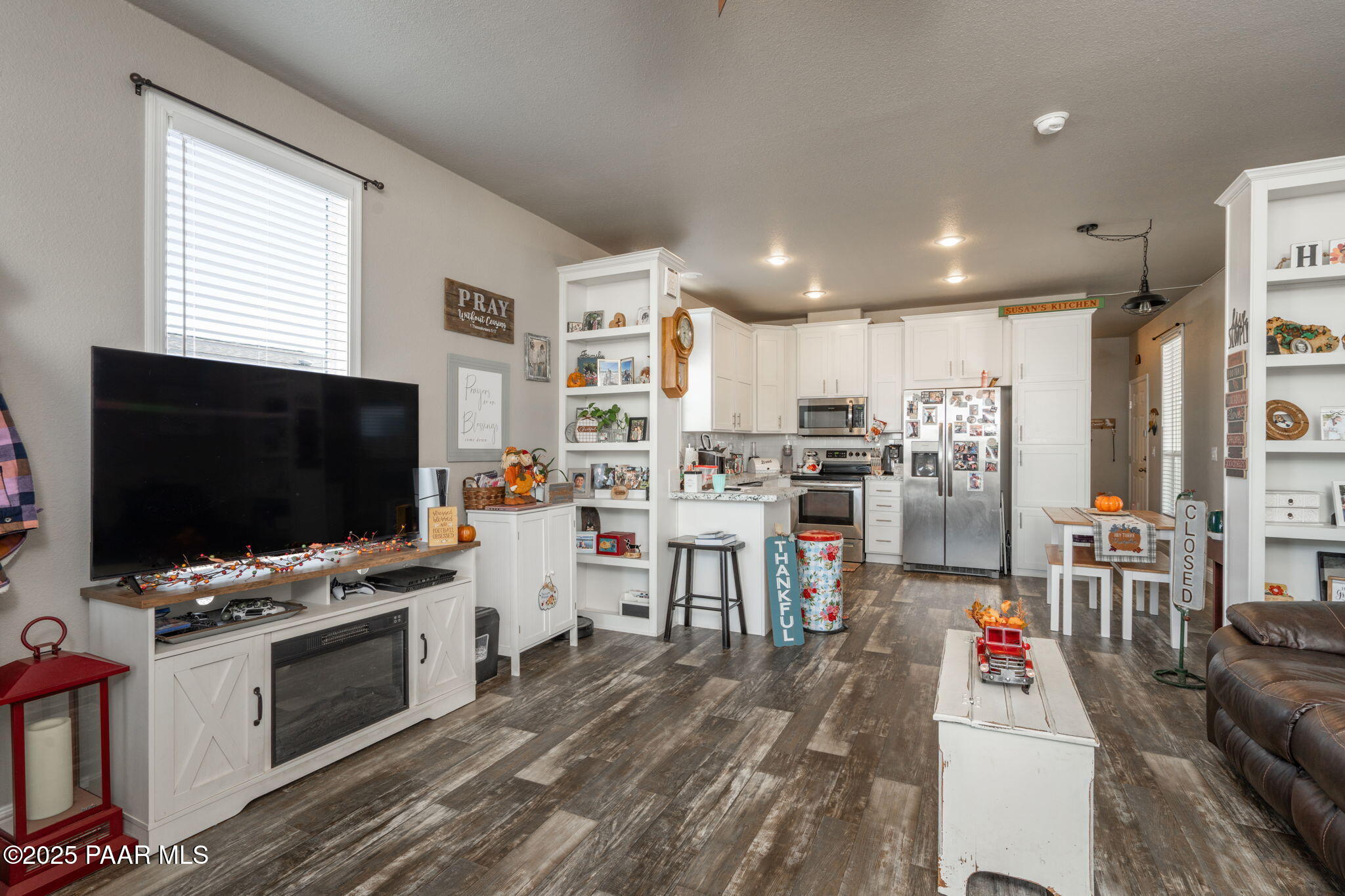 1023 Thorton Road Camp Verde, AZ 86322 - Photo 8 of 29 a living room with stainless steel appliances kitchen island furniture a flat screen tv and kitchen view