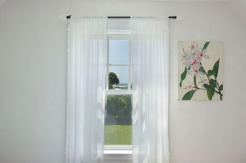 a bedroom with a large bed and a window