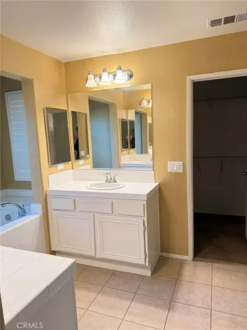 a bathroom with a sink a mirror and a bathtub