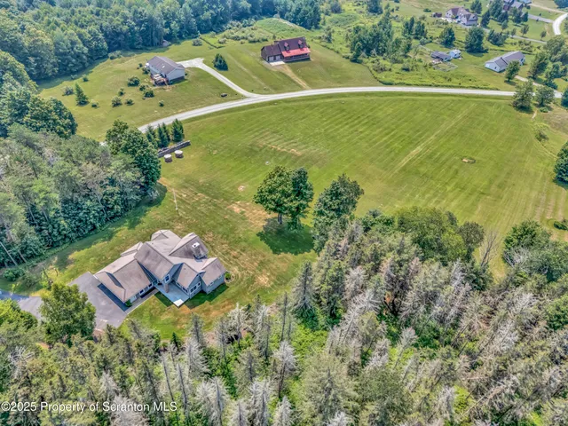 a kitchen with stainless steel appliances a table chairs in it and wooden floors