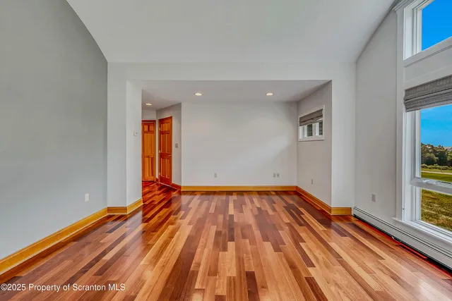 a view of empty room with wooden ceiling
