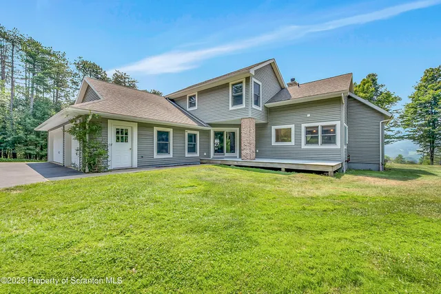 a view of a house with a backyard