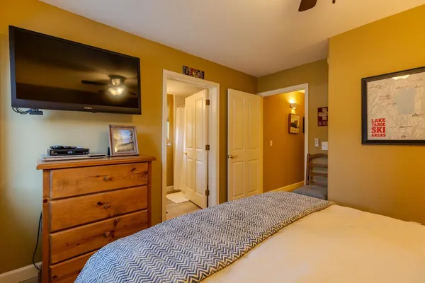 a bedroom with a bed and a flat screen tv