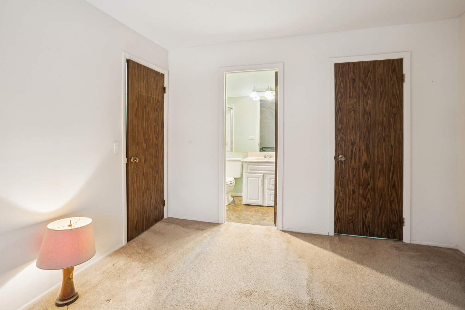 28 Regent Circle, Unit B2 Schaumburg, IL 60193 - Photo 12 of 22 a view of a bathroom with a sink and a toilet