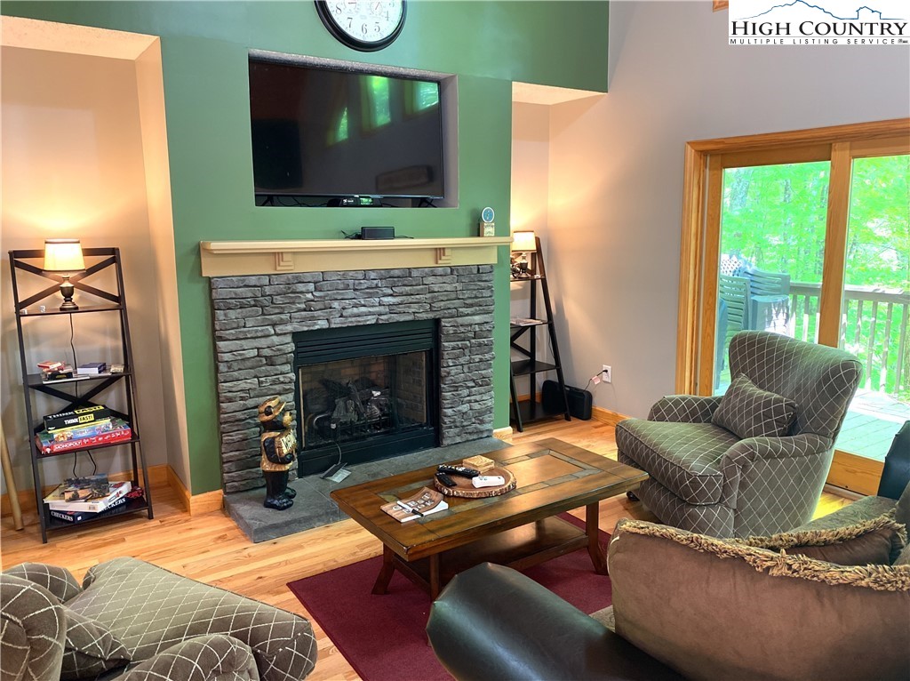 402 Pinnacle Ridge Road Beech Mountain, NC 28604 - Photo 2 of 44 a living room with furniture a flat screen tv and a fireplace