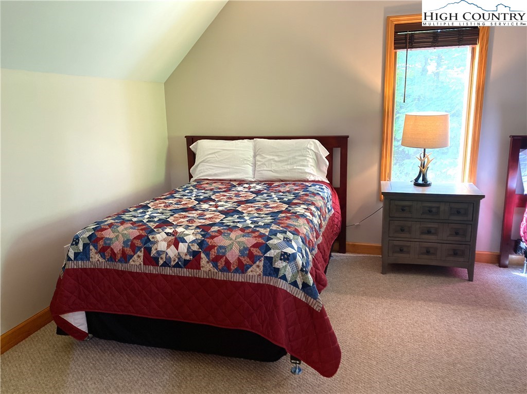402 Pinnacle Ridge Road Beech Mountain, NC 28604 - Photo 23 of 44 a bedroom with a bed window and a dresser