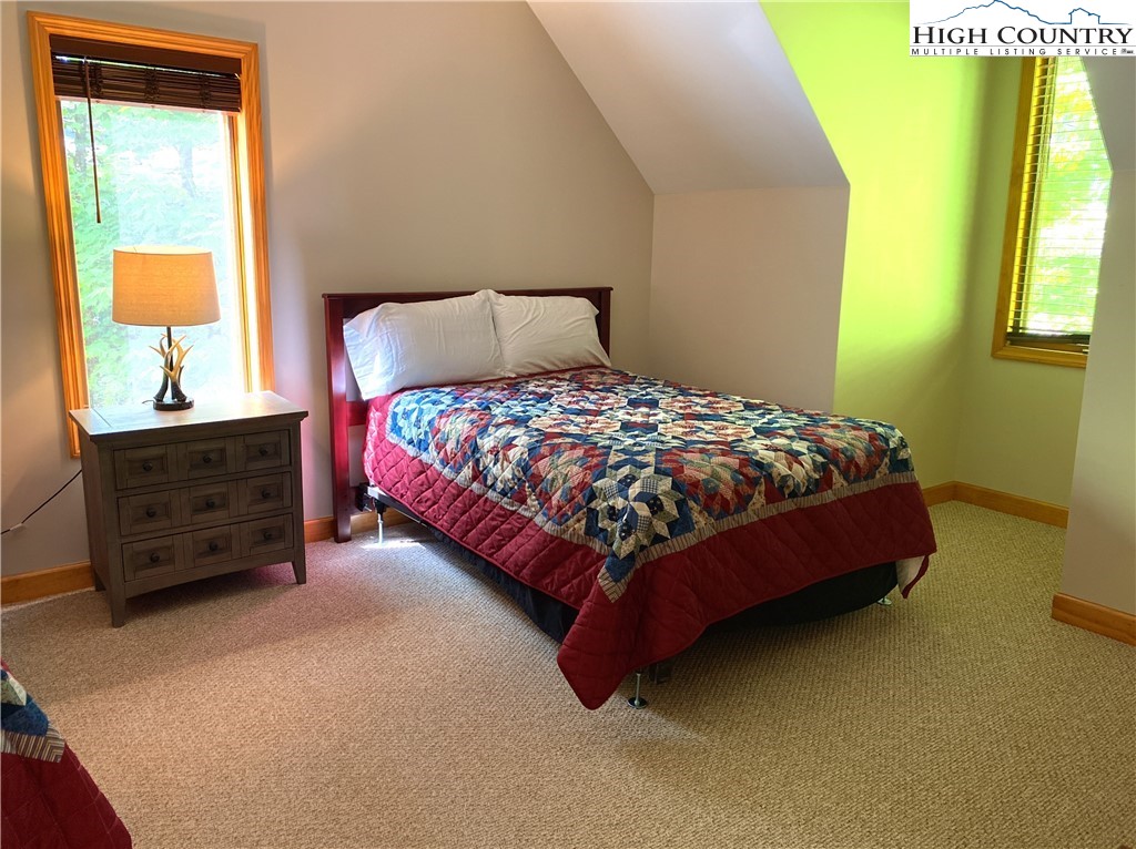402 Pinnacle Ridge Road Beech Mountain, NC 28604 - Photo 24 of 44 a bed sitting in a bedroom next to a window